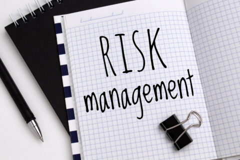 The words Risk Management written on a writing pad.