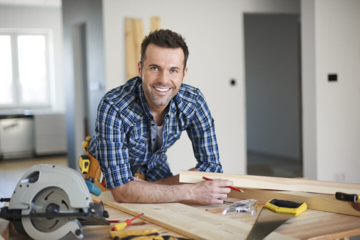 Smiling builder st his workbench