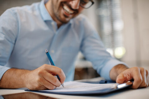 Young businessman signing a contract.